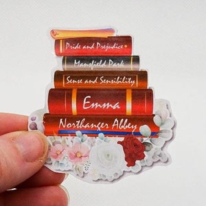 May include: A stack of five books with floral accents. The books are titled "Pride and Prejudice", "Mansfield Park", "Sense and Sensibility", "Emma", and "Northanger Abbey".