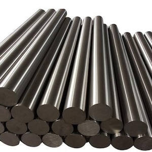 May include: A collection of shiny, cylindrical metal rods. The rods are stacked in a pile, with the ends of the rods visible, showing a circular cross-section. The metal has a polished, reflective surface.