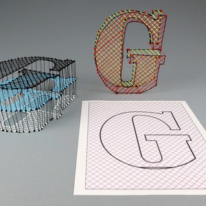 May include: Three dimensional string art of the letter G. The first G is made with black string on a white grid, the second G is made with red and yellow string on a white grid, and the third G is a black outline on a white grid with red and blue lines.