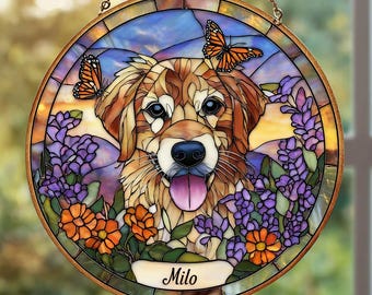 May include: Round stained glass window featuring a dog with a lolling tongue, surrounded by purple and orange flowers and two orange butterflies. The dog's name, "Milo", is written on a banner at the bottom. The window is framed in a gold-colored metal.