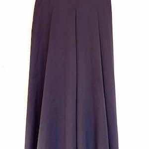 May include: A dark blue midi skirt with a red belt. The skirt has a flared silhouette and a simple design.