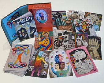 May include: A colorful deck of cards with the words "Diversity Deck" on the cover. The cards feature a variety of illustrations, including a person riding a bicycle, a hand with painted nails, and a person holding a baby. The cards are arranged in a fan shape on a white surface.