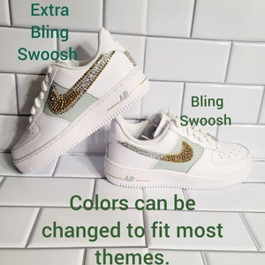May include: White leather sneakers with a light green and gold swoosh decorated with rhinestones. The text "Extra Bling Swoosh" and "Bling Swoosh" are visible in the image. The text "Colors can be changed to fit most themes." is also visible in the image.
