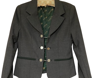 May include: A gray blazer with black trim and gold buttons. The lining is green with a repeating pattern of a horse and rider.