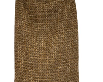 May include: A brown and gold tweed skirt with a straight silhouette.