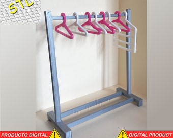 May include: A gray metal clothing rack with six pink plastic hangers and a white plastic shelf. The rack has a rectangular base and two vertical supports. The text "STL" is visible in the upper left corner of the image.