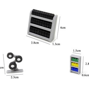 May include: Three miniature toy shelves for a dollhouse or miniature scene. The shelves are gray and have black tires on them. The shelves are 4 inches tall, 1.3 inches wide, and 3.8 inches long. The other shelf is 1.5 inches tall, 0.66 inches wide, and 2.8 inches long. The shelf has three shelves with green, yellow, and blue items on them. The other shelf is 3.2 inches tall, 2.3 inches wide, and has three black tires on it.