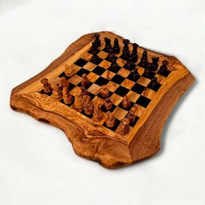 May include: A wooden chess set with a live edge border. The chessboard features a black and tan checkered pattern. The chess pieces are carved from wood and are arranged on the board, ready for play.
