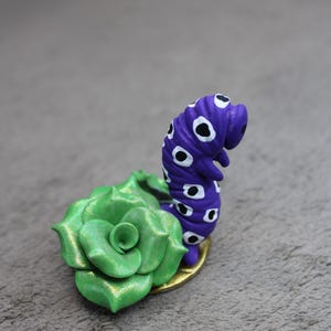 polymer clay caterpillar with flowers sculpture
