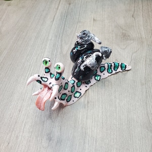 Hand sculpted Alien snail with shell and skulls