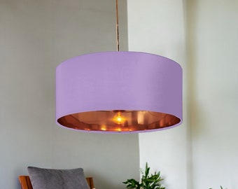 May include: A purple lampshade with a copper interior. The lampshade is hanging from a ceiling fixture.