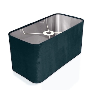 May include: A dark blue rectangular lampshade made of velvet fabric.