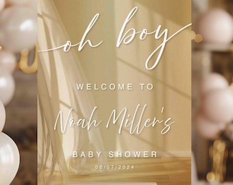 May include: A welcome sign for a baby shower with a light brown background and white text. The text reads "Oh boy! Welcome to Noah Miller's Baby Shower 06/07/2024".
