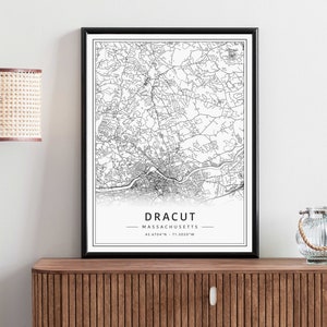 May include: Black and white printable map of Dracut, Massachusetts. The map shows the city's streets and landmarks. The text "Dracut, Massachusetts 42.6704&deg;N - 71.3020&deg;W" is printed below the map.