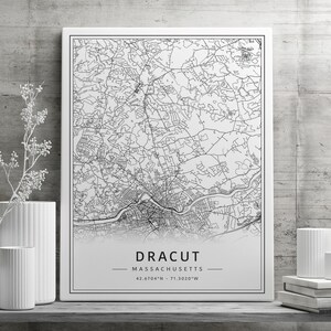 May include: Black and white line art map print of Dracut, Massachusetts. The map shows the city streets and includes the coordinates 42.6704&deg;N -71.3020&deg;W.