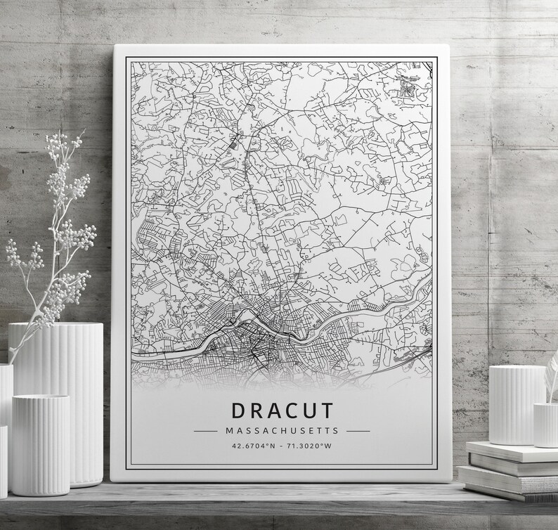 May include: Black and white line art map print of Dracut, Massachusetts. The map shows the city streets and includes the coordinates 42.6704&deg;N -71.3020&deg;W.