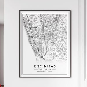 May include: A black and white line art map print of Encinitas, California. The map shows the streets and roads of the city. The text "Encinitas, California" and the coordinates "33.0370°N - 117.2920°W" are printed below the map.