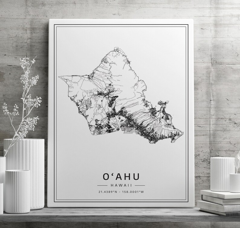 May include: Black and white line art print of the island of Oahu, Hawaii. The print includes the text "O'AHU" and "HAWAII" with the coordinates "21.4389&deg;N - 158.0001&deg;W".