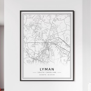 May include: Black and white line art map of Lyman, South Carolina. The map shows the city streets and surrounding area. The text "Lyman, South Carolina" and the coordinates "34.9557°N - 82.1276°W" are printed below the map.