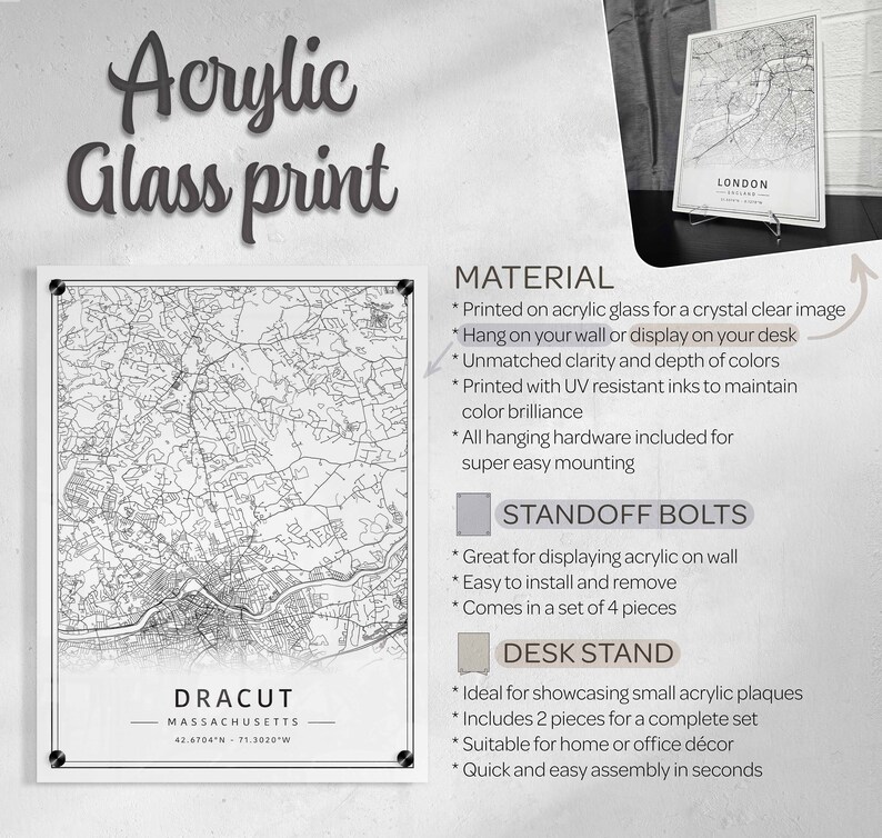 May include: A black and white map of Dracut, Massachusetts printed on acrylic glass. The map is framed with a black border and includes the city name and coordinates. The image also shows options for displaying the map, including standoff bolts and a desk stand.