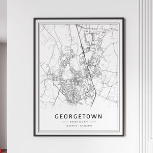 May include: Black and white line art map of Georgetown, Kentucky. The map shows the city streets and landmarks. The text "GEORGETOWN - KENTUCKY - 38.2098°N - 84.5588°W" is at the bottom of the map.