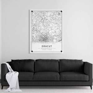 May include: Black and white line art map print of Dracut, Massachusetts. The map shows the city streets and features the city name and coordinates.
