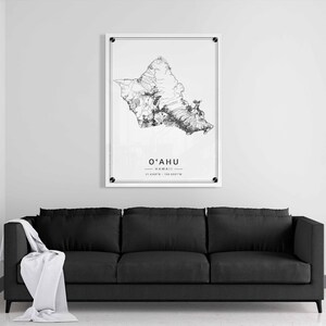May include: A black and white line art print of the island of Oahu, Hawaii. The print includes the name "O'AHU" and the coordinates "21.4389&deg; N - 158.0001&deg; W".