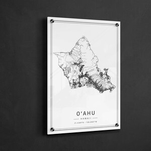 May include: A black and white line art map of the island of Oahu, Hawaii. The map is on a white background with the text "O'AHU - HAWAII - 21.4389&deg;N - 158.0001&deg;W" printed below the map.