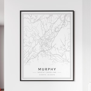 May include: A black and white line art map of Murphy, North Carolina. The map shows the city's streets, rivers, and other features. The text "MURPHY NORTH CAROLINA 35.0876°N - 84.0346°W" is printed below the map.