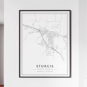 May include: Black and white line art map of Sturgis, South Dakota. The map shows the city streets and surrounding area. The text "Sturgis, South Dakota" and the coordinates "44.4097°N - 103.5091°W" are printed below the map.