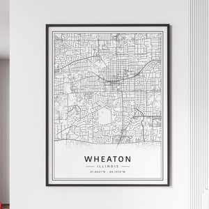 May include: Black and white line art map of Wheaton, Illinois. The map shows the city streets and includes the text "WHEATON, ILLINOIS, 41.8661°N - 88.1070°W".