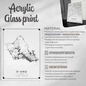 May include: A black and white line art map of the island of Oahu, Hawaii. The map is printed on acrylic glass and has the coordinates 21.4389&deg;N 158.0001&deg;W printed below the map. The text "OʻAHU" and "HAWAII" are printed above the map. The image shows the text "Acrylic Glass Print" at the top of the image. The image also shows the text "MATERIAL" and a list of features of the product. The text "STANDOFF BOLTS" and "DESK STAND" are also shown with a list of features for each.