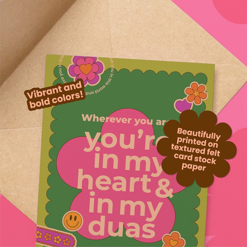 May include: A greeting card with a green background and a large pink flower shape containing the text "you're in my heart & in my duas". The card has a brown envelope behind it. The card has a retro design with the words "Vibrant and bold colors!" and "Beautifully printed on textured felt card stock paper".