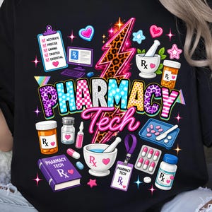 May include: A black t-shirt featuring a colorful graphic print with the text PHARMACY Tech. The design includes a leopard print lightning bolt, a clipboard with checkmarks, prescription bottles, a mortar and pestle, pills, and a badge.
