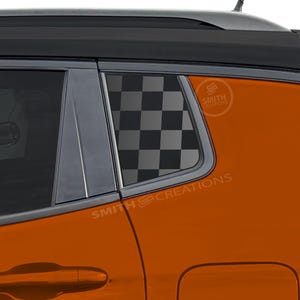 May include: An orange car window with a black and gray checkered pattern applied to the glass. The text "SMITH CREATIONS" is visible on the car's body.