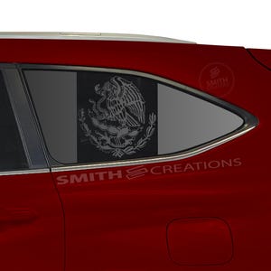 May include: A red car with a window decal featuring the Mexican coat of arms. The decal is a detailed, gray-scale image of an eagle with a snake in its beak, surrounded by a wreath. The text "SMITH CREATIONS" is visible.