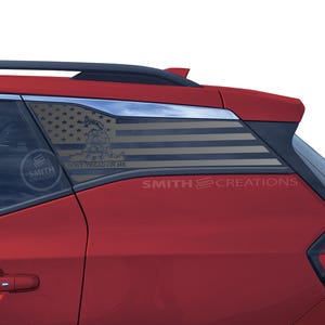 May include: A red SUV with a black American flag decal on the rear window. The decal features the words "Don't Tread On Me" and a snake.