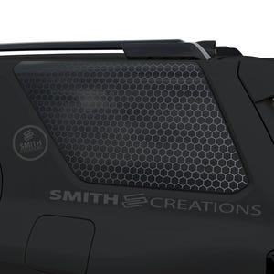 May include: Black vehicle window with a honeycomb pattern overlay. The text "SMITH CREATIONS" is displayed on the vehicle. A circular logo with the text "SMITH PREMIUM" is also visible.