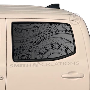 May include: A white truck with a decorative window decal featuring a black tribal design. The decal is visible through the window. The text "SMITH CREATIONS" is printed on the side of the truck.