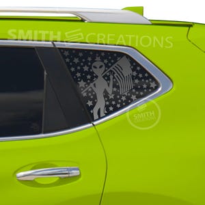 May include: A lime green car with a window decal featuring a gray alien holding an American flag. The window is decorated with a star pattern. The text "SMITH CREATIONS" is visible.