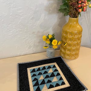 Triangles of many colors 11” blue floral/black triangles with red and black border or 12”blue dot/black/white with white and black border