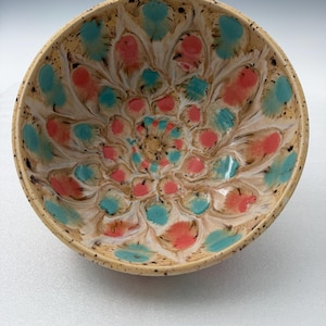 May include: A white ceramic mug with a black handle and the text "But First, Coffee" in a black, bold font. The mug is sitting on a white surface. The mug is approximately 4 inches tall.