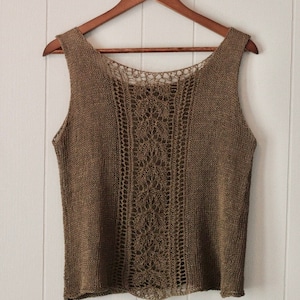 May include: A brown sleeveless knitted top with a crocheted lace design on the front and back.