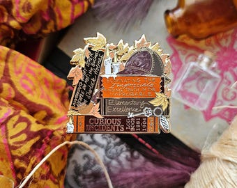 May include: Gold-toned enamel pin featuring a stack of books with autumn leaves and a detective's hat. The books have titles like "Eliminating the Impossible" and "Curious Incidents".