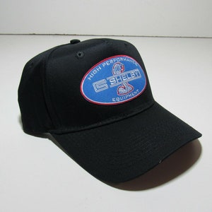 May include: Black baseball cap with a blue oval patch that says "High Performance Shelby Equipment" with a white cobra logo inside the oval.