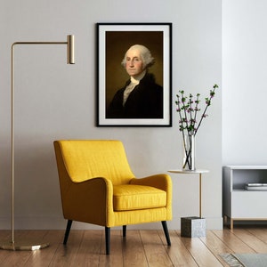 May include: A yellow armchair with black legs sits in a living room with a framed portrait of George Washington, a vase of flowers, and a television on a white cabinet.