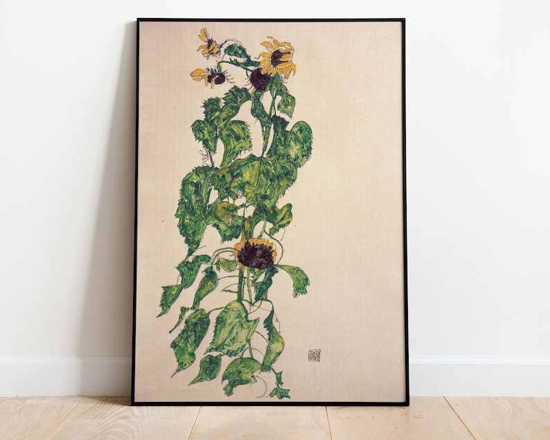 May include: A vintage art print of a sunflower plant with yellow petals and green leaves. The print is on a cream-colored background and has a black frame.