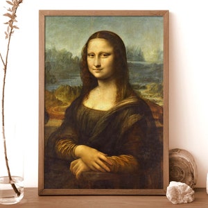 May include: A framed painting of the Mona Lisa, a famous portrait by Leonardo da Vinci. The painting depicts a woman with a soft smile, wearing a dark dress and a light background.