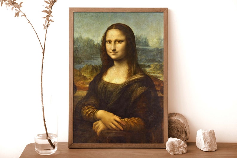 May include: A framed painting of the Mona Lisa, a famous portrait by Leonardo da Vinci. The painting depicts a woman with a soft smile, wearing a dark dress and a light background.