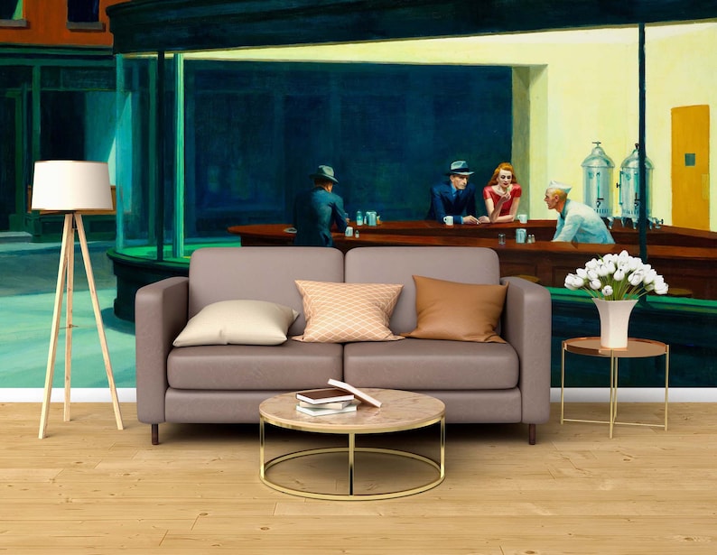May include: A painting of a diner scene with four people sitting at the counter. The painting is on a wall behind a brown couch, a coffee table, and a side table with a vase of white flowers.